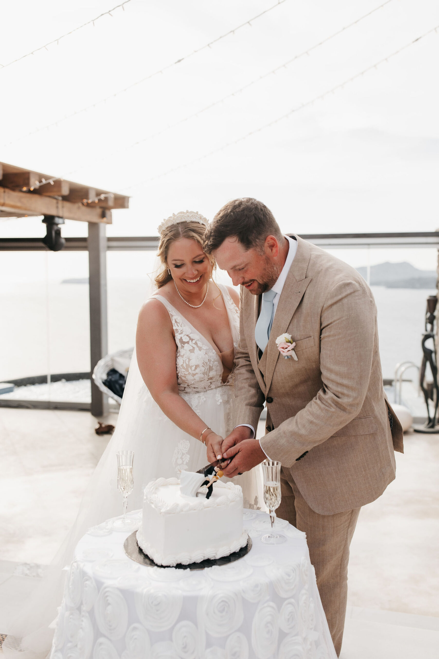 Couple cuts cake at their destination wedding in Greece
